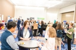People chatting around tables on the Healthcare Waste Conference Show Floor