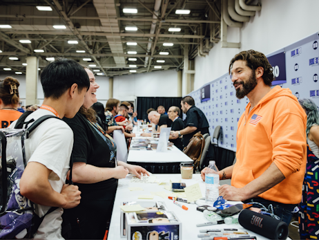 Jon Bernthal at his table talking to two fans