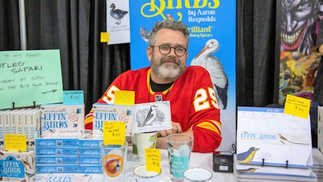 Aaron Reynolds smiles at his booth
