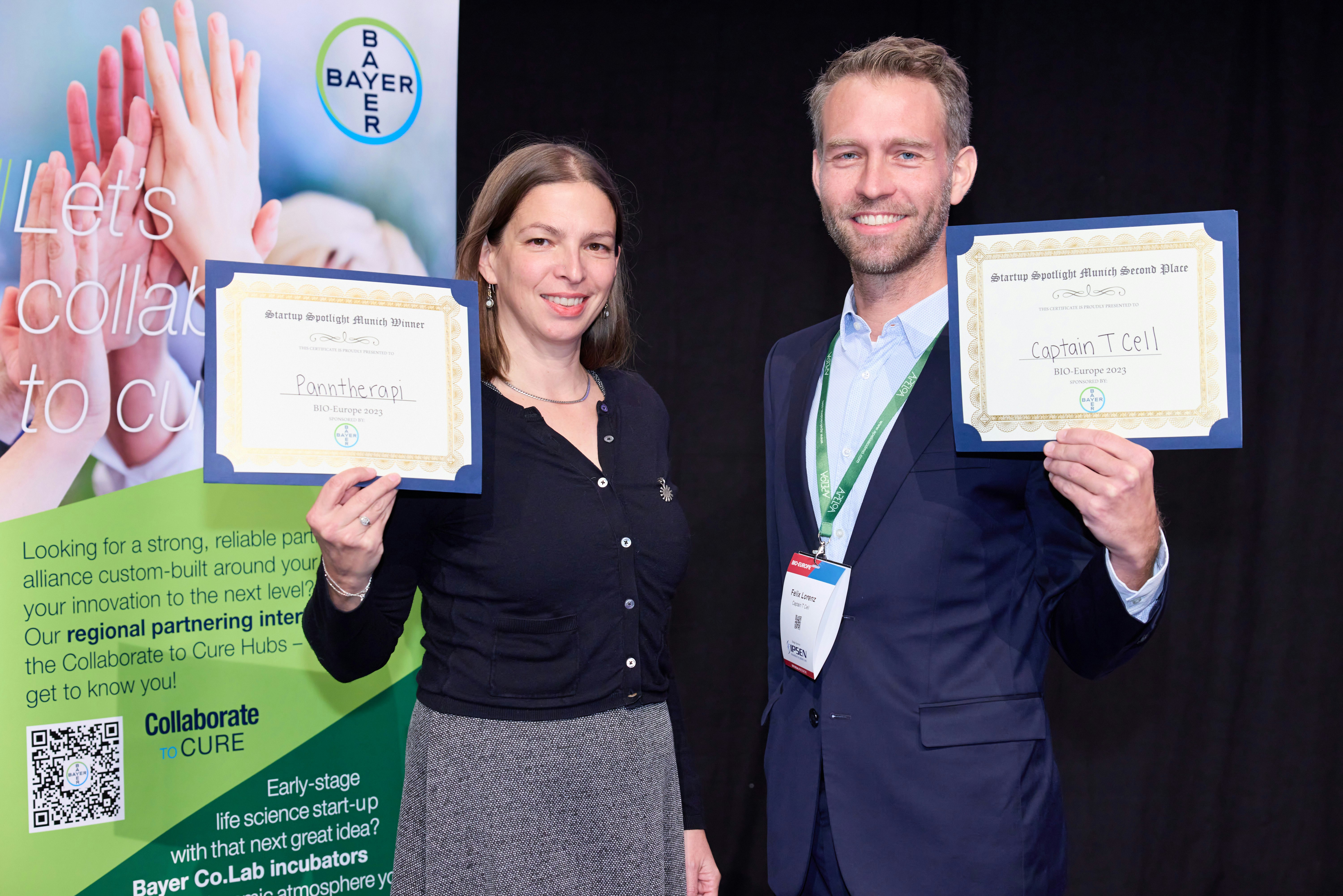 Two previous Startup Spotlight Winners, Pantheaon and Capital Tcell, holding a certificate