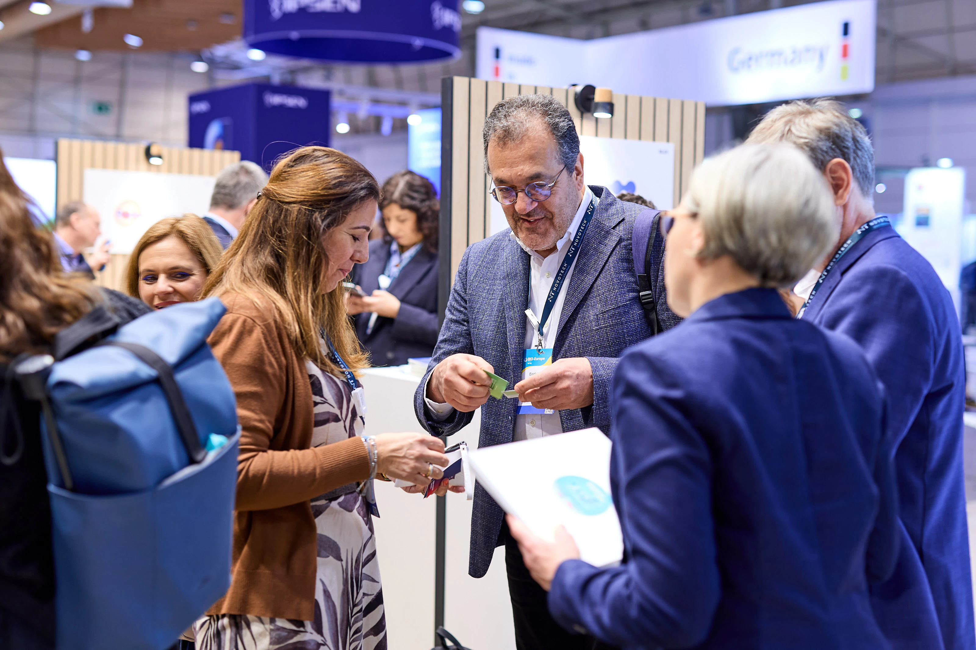 A group exchanging business cards at BIO-Europe Spring