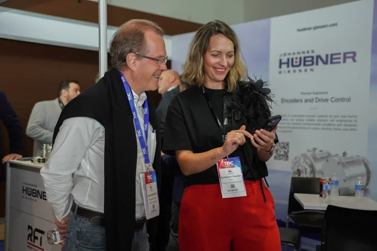 Event participants interacting at an exhibition stand.