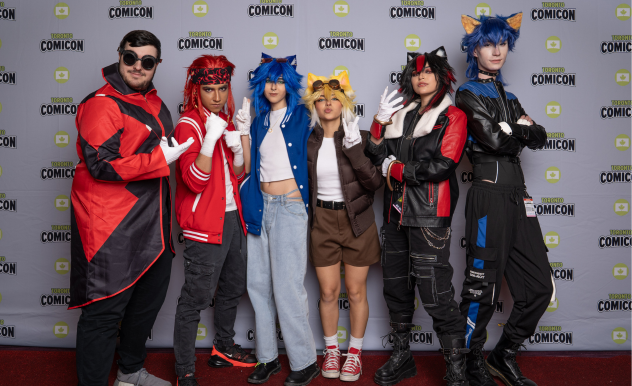 A group of cosplayers dressed as the Sonic squad pose together on the Toronto Comicon backdrop