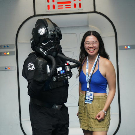 A fan poses with a member of the 501st at one of the photo ops at their booth. The fan, right, smiles a wide smile as the trooper holds up a fist. 
