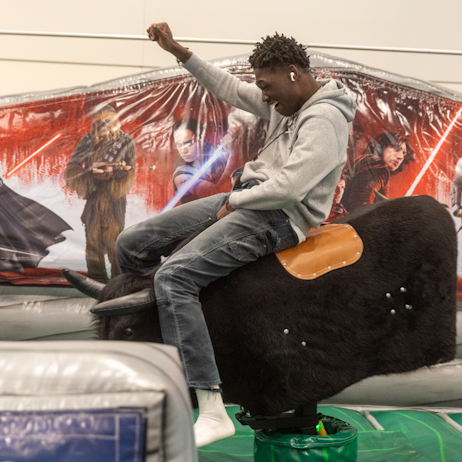 Fan riding a mechanical bull