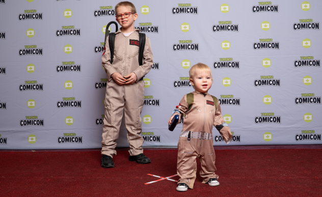 Brothers dressed as Ghostbusters pose on the red carpet