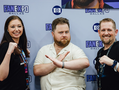 Paul Walter Hauser (middle) posing as Cobra Kai characters, with a woman on the left, and a man on the right.