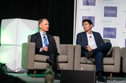 2 presenters talking to each other on stage at the Investor Summit