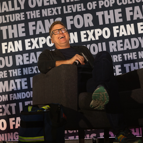 Alan Tudyk laughing as he sits on his panel