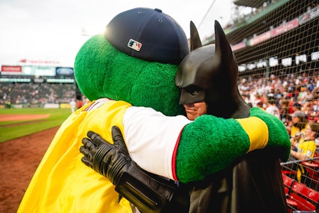 Batman and a mascot hugging