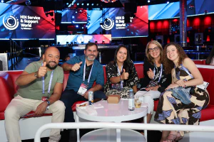 Conference attendees celebrate and connect at an HDI Service & Support World networking event, building relationships beyond the classroom.