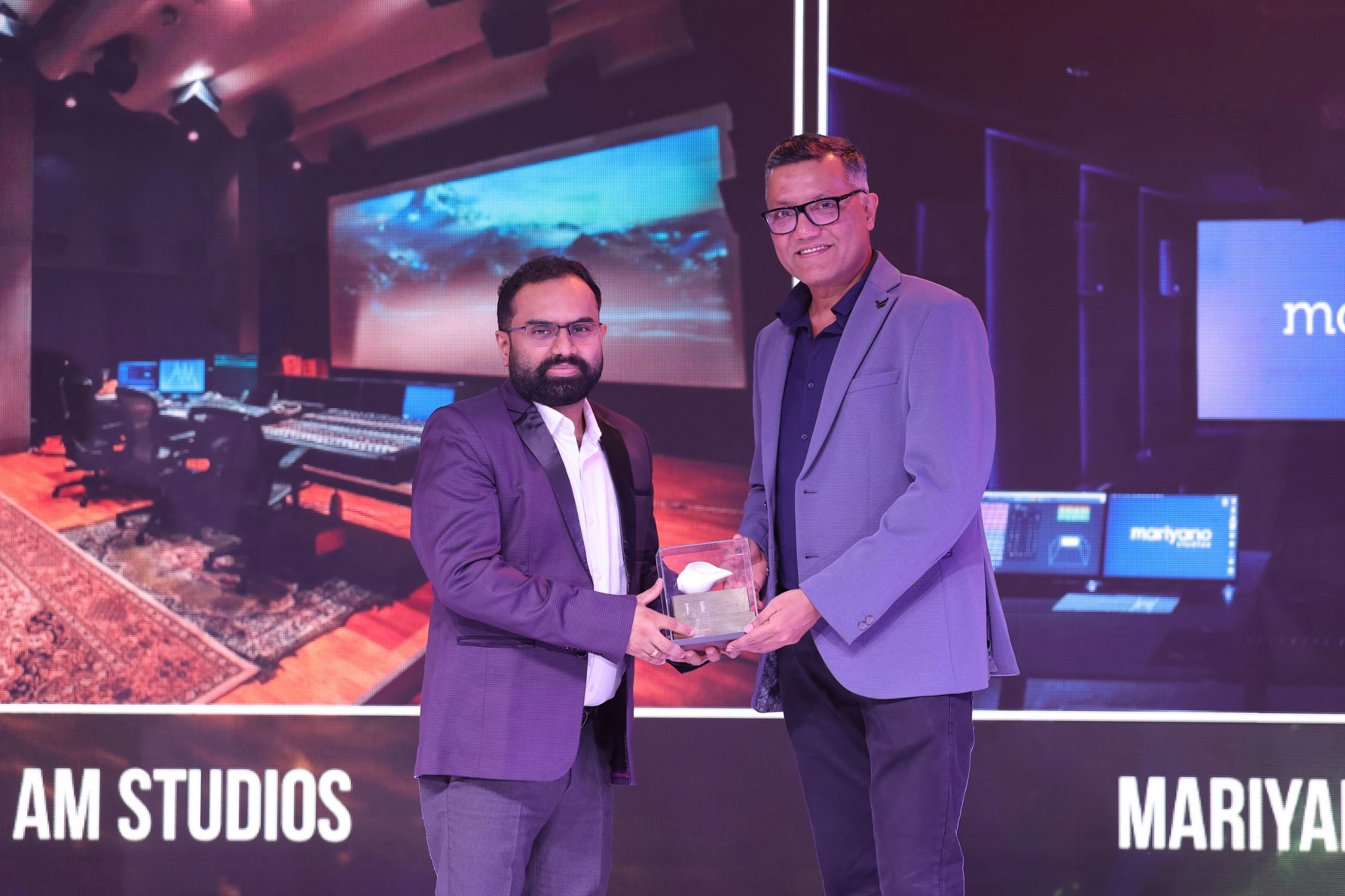 IRAA 2025 - Krishnan Subramanian receives the award on behalf of Riyasdeen Riyan & S Sivakumar for AM Studios for Studio of the Year