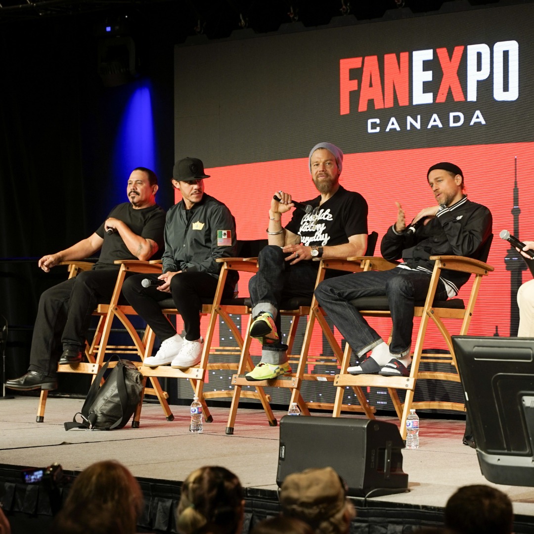 The Sons of Anarchy cast are sitting on stage beside each other for their panel at FAN EXPO Canada.