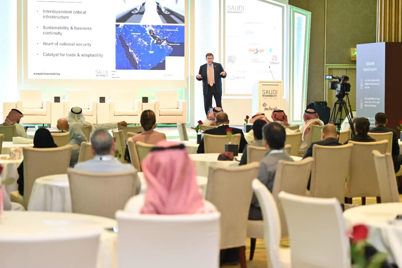 Man presenting in a conference in front of audience.