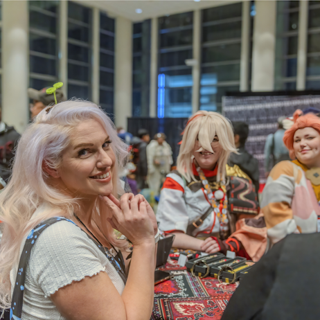 Cosplay guest posing for a pic in front of fans