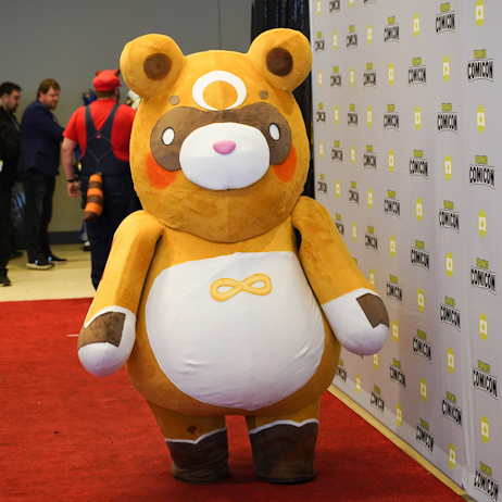 Guoba from Genshin Impact, a large, brown, bear-like creature, waddles down the red carpet.