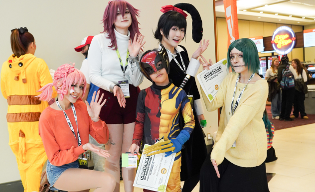 Snacck Box pose with their "Best Mashup" winner - a boy dressed as Deadpool AND Wolverine.