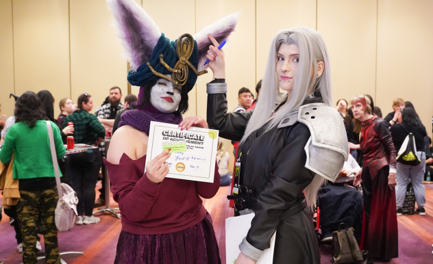 BreadBren poses with a League of Legends cosplayer who has been awarded a cosplay hallway award and badge ribbon