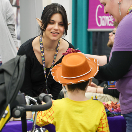 Vendor chatting with young fan dressed as Woody from Toy Story