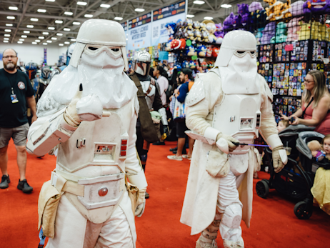 two star wars cosplayers dressed as storm troopers.