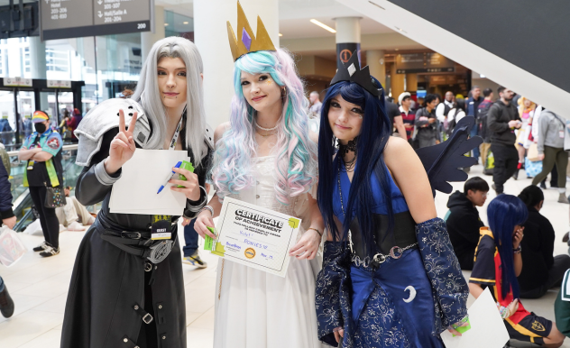 BreadBren poses with a cosplay duo dressed as My Little Pony ponies, their award is for their pair.