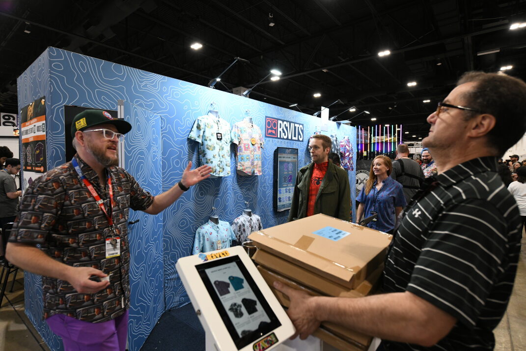 The team from RSVLTS (Rosevelts) discuss product with fans at their large blue booth
