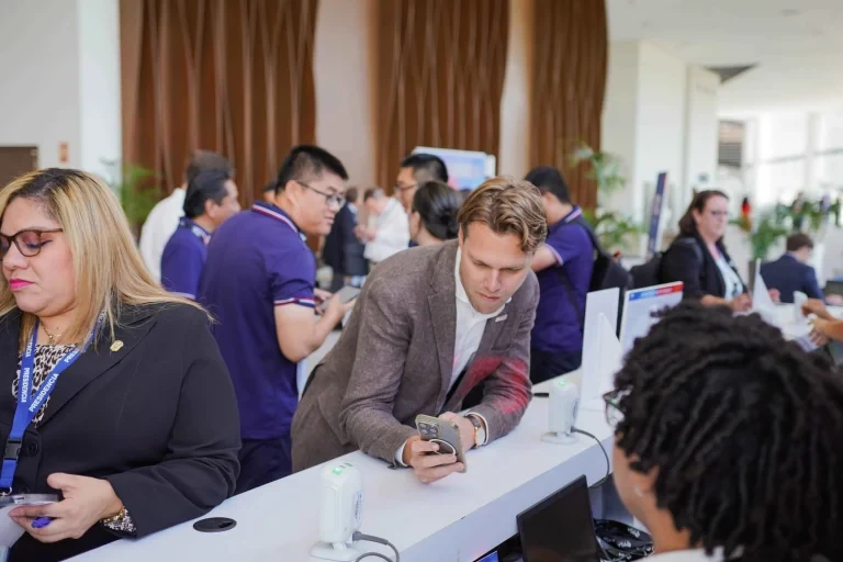 Participants registering at the event reception area.