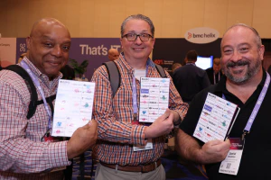 Attendees show completed Passport to Prizes cards after exploring the Expo Hall and connecting with exhibitors.
