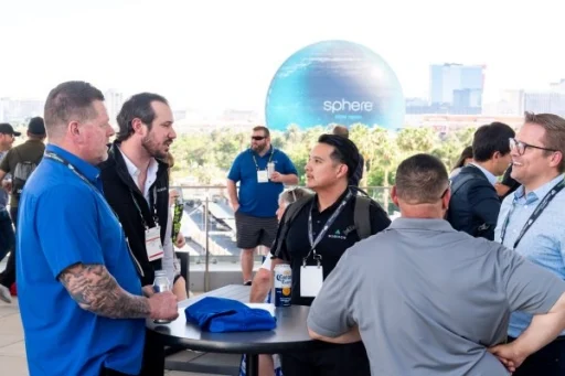 Group of men chatting at a tabale at the public sector reception