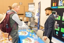 Man speaking with an exhibitor about his products at the Healthcare Waste Conference