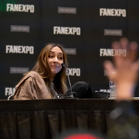 Sarah Natochenny on her panel with a fan raising their hand for a question