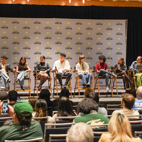 The cast of Davey and Jonesie's locker sits on the main stage. There are 9 people.