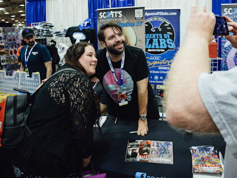 Comic artist James Tynion IV posing for a photo with a fan