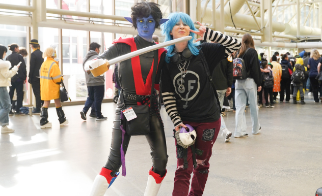 A pair pose in the expo hall, The first is dressed as Nightcrawler (X-Men) and the other is in plain clothes