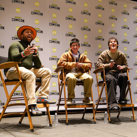 From left to right, our Moderator prompts the fans for applause as Gordon Cormier and Ian Ousley laugh and smile at the interaction