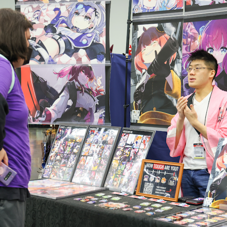 Artist talking to fan about their work