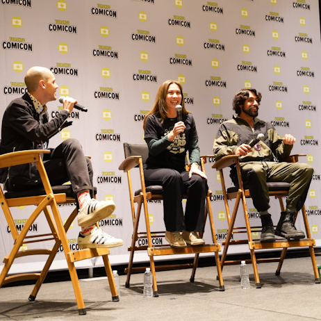 From left to right: Moderator is wearing black jacket and black jeans, centre: Diana Lee Inosanto wears all black, right: Eman Esfandi wears an olive green and black track suit. They smile and listen as fans ask questions