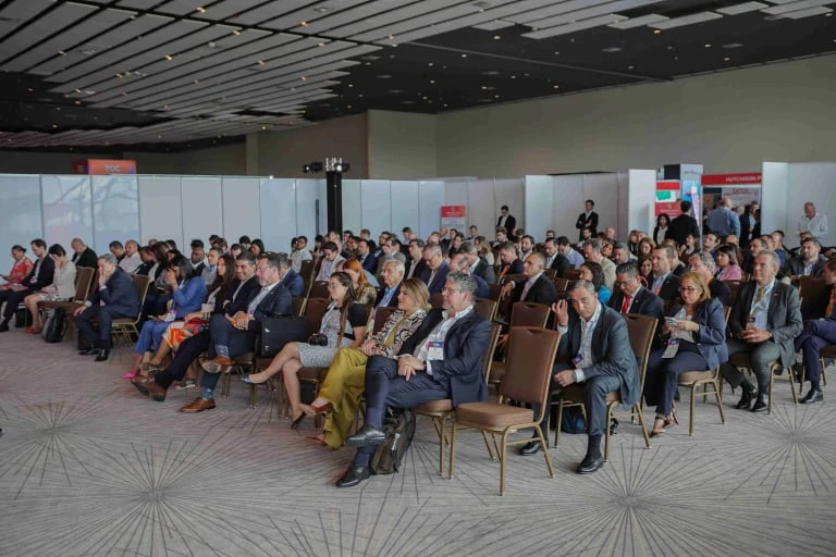 Audience seated during a session at the TOC Americas event.