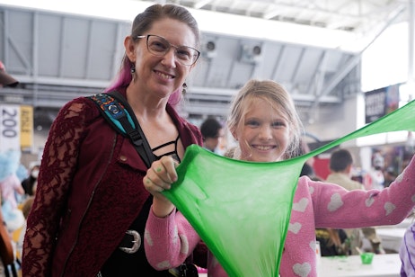 A mother and daughter pose with Ghostbusters green slime