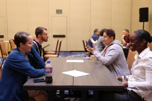 Attendees participate in a speed networking session, exchanging ideas and making new professional connections through structured one-on-one conversations.