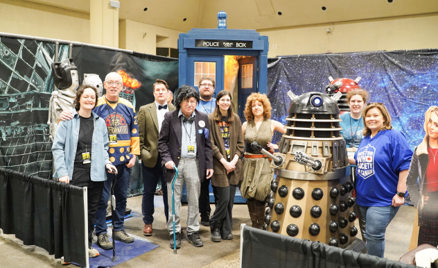 The Doctor Who Society pose together with the TARDIS and Dalek at their Community Zone booth.