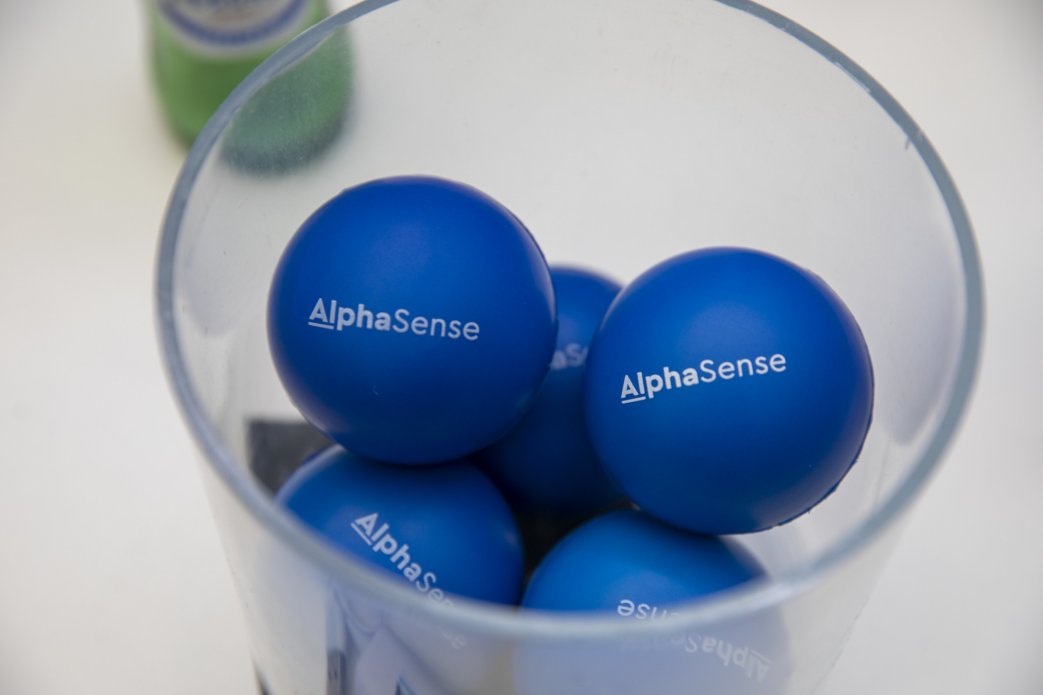 AlphaSense branded stress balls in a glass