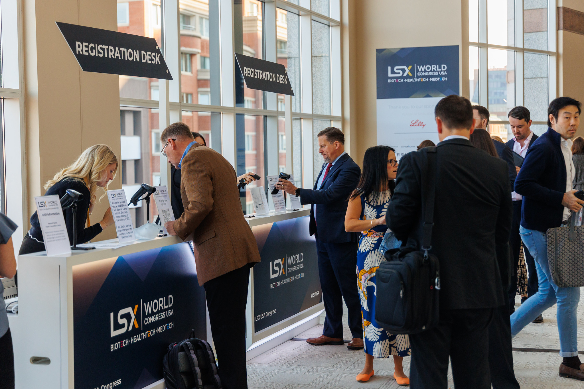 The registration desk at LSX USA Congress with attendees checking in.