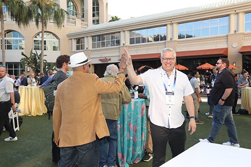 Enterprise Communications Conference attendees high fiving each other