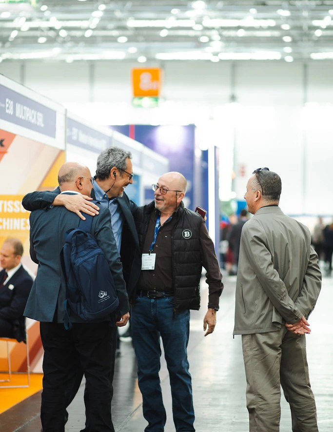 Exhibitor talking to visitors at Tissue World