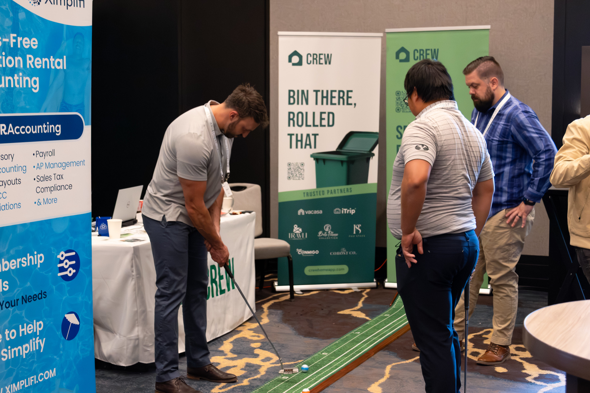 Golf playing at a sponsor booth at Short Term Rental Summer