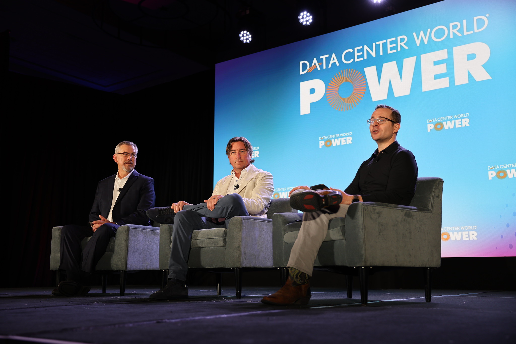 Data Center World attendees smiling at camera