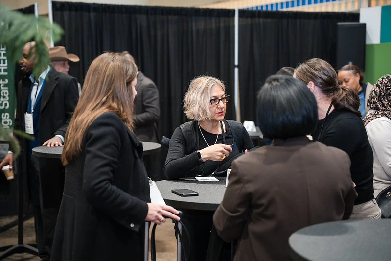 Attendees connecting and engaging in conversation during the Networking Mixer