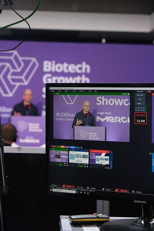 A speaker leads a session by a podium at LSX Investival Europe