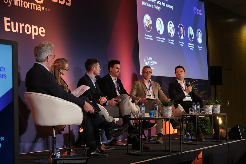 6 panellists sit on stage with a host leading a session at LSX Investival Europe